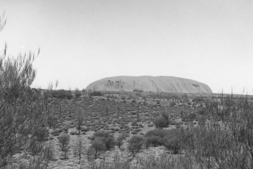 Black and white photo of Uluru from a distance