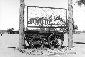 Black and white photo of the Uluru Camel Tours sign