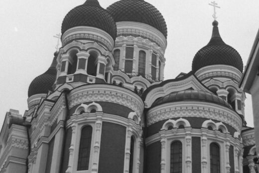 Black and white photo of a Russian style cathedral with onion domes.