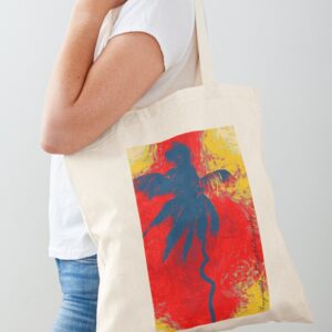 A picture of a woman with a tote bag slung on her shoulder. The image on the bag is of a blue and red back ground and a blue palm tree. The palm tree has a curl in it's trunk. The image is signed Frogmouth Cottage Photography.