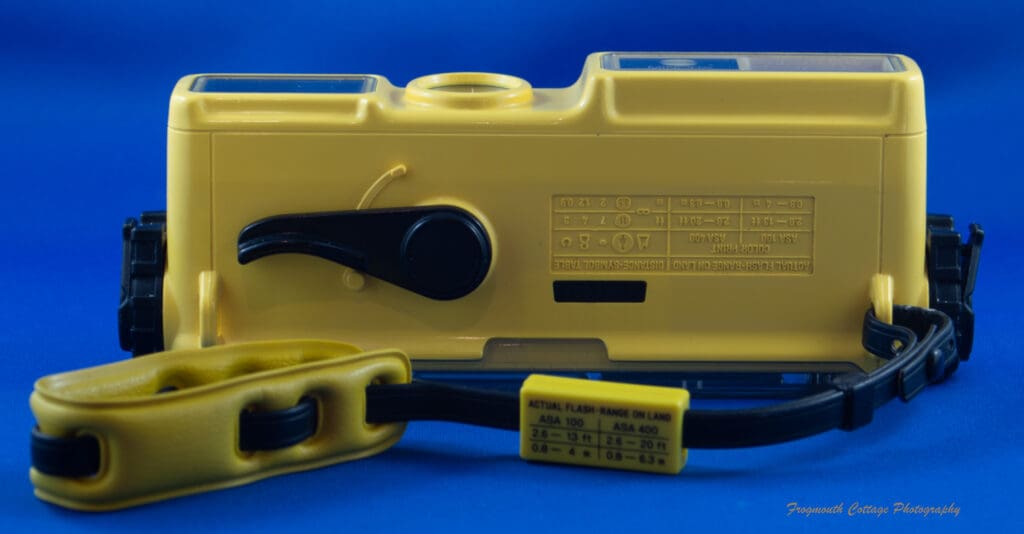 Photograph of the bottom of the Minolta Weathermatic A with the film advance winder.